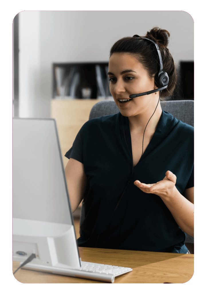 woman with headphones on facing a monitor for customer services